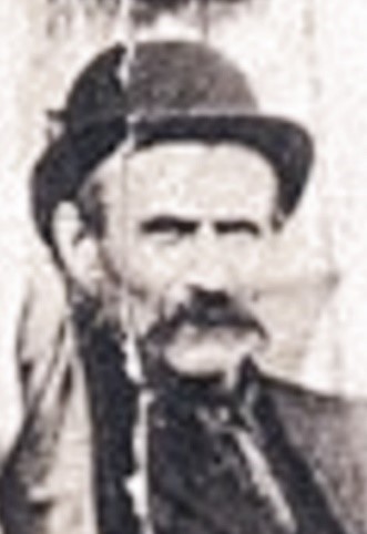 Black and white photograph of a man wearing a hat